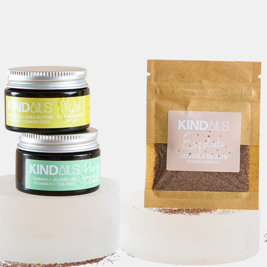 Two jars and a brown paper bag with kind oils branding on a white background.