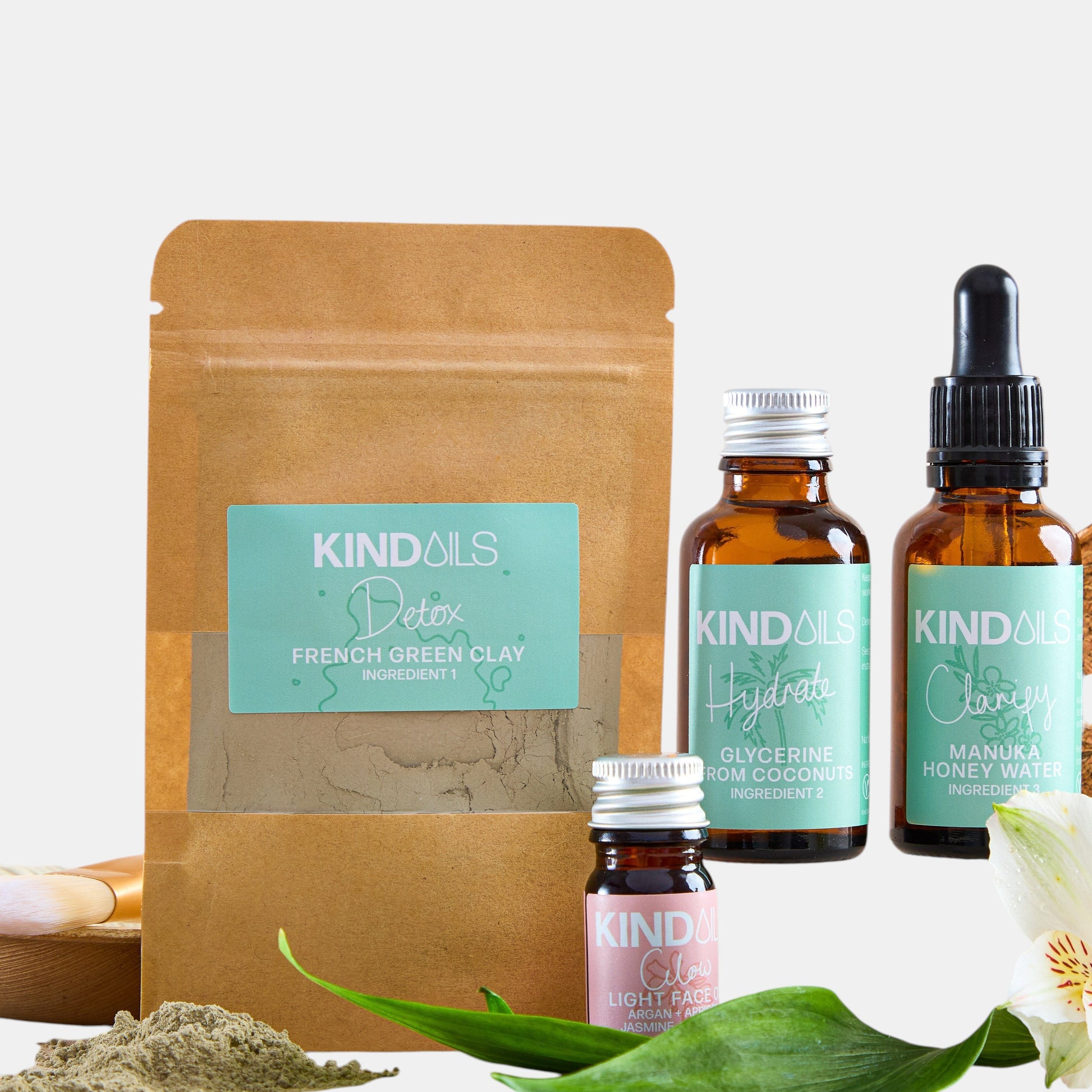 Collection of Kind Oils products including bottles and a packaging bag on a white background.