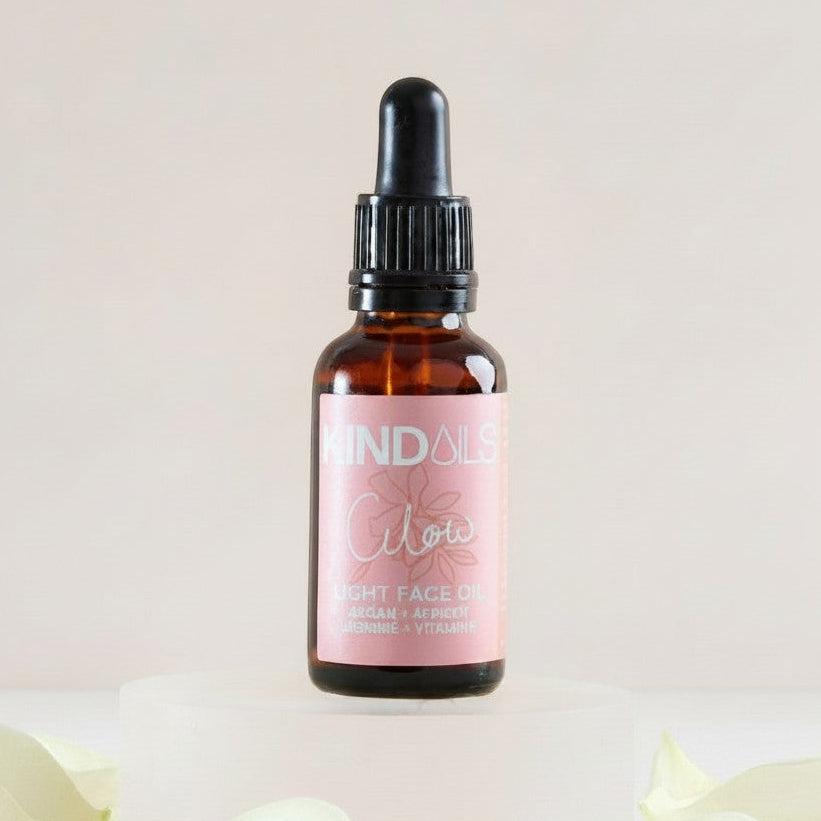Kind Oils Glow Light Face Oil in amber glass bottle with dropper, 30ml, featuring botanical ingredients for radiant skin.
