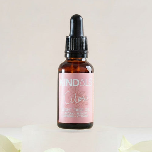 Kind Oils Glow Light Face Oil in amber glass bottle with dropper, 30ml, featuring botanical ingredients for radiant skin.