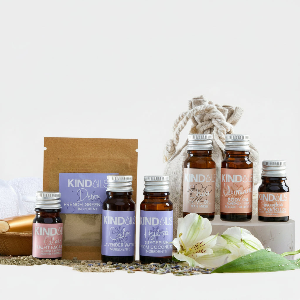 Collection of Kind Oils products including bottles and a box on a white surface with a white background.